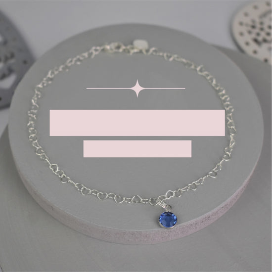 Video showing Sterling silver heart shaped links form this pretty anklet hung with a tiny blue crystal. 