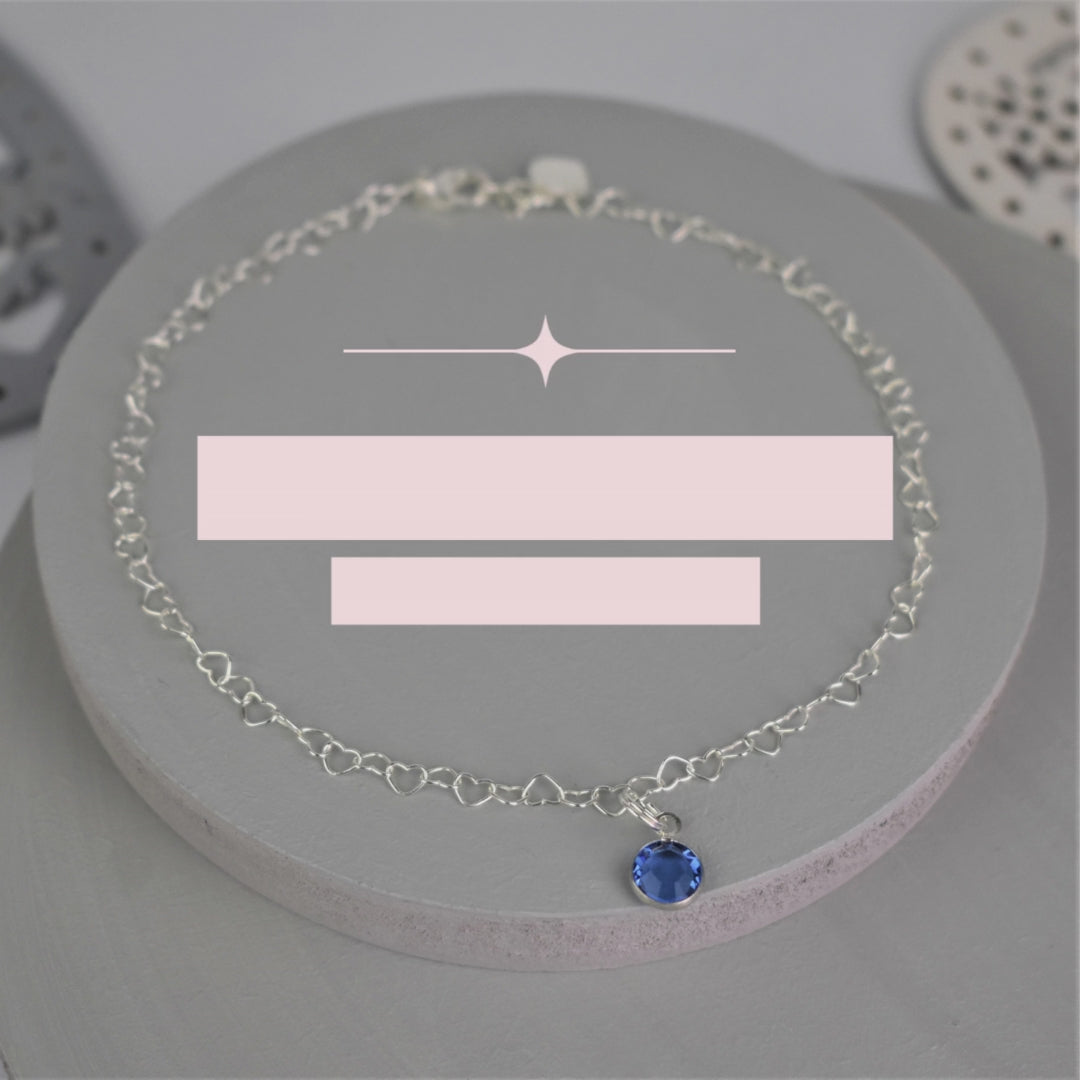 Video showing Sterling silver heart shaped links form this pretty anklet hung with a tiny blue crystal. 