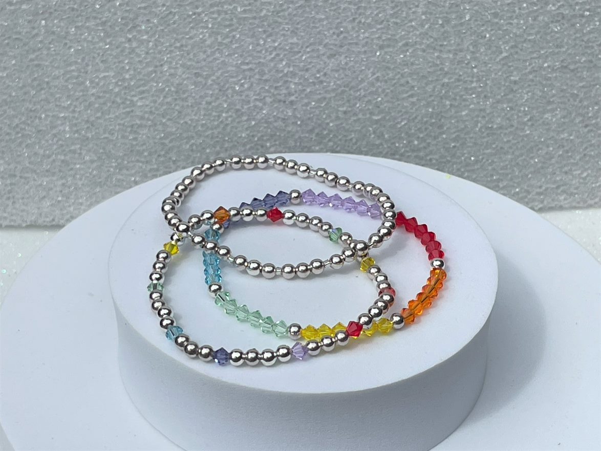 silver plated bead bracelet shown with rainbow crystal bracelet and rainbow bead bracelet.