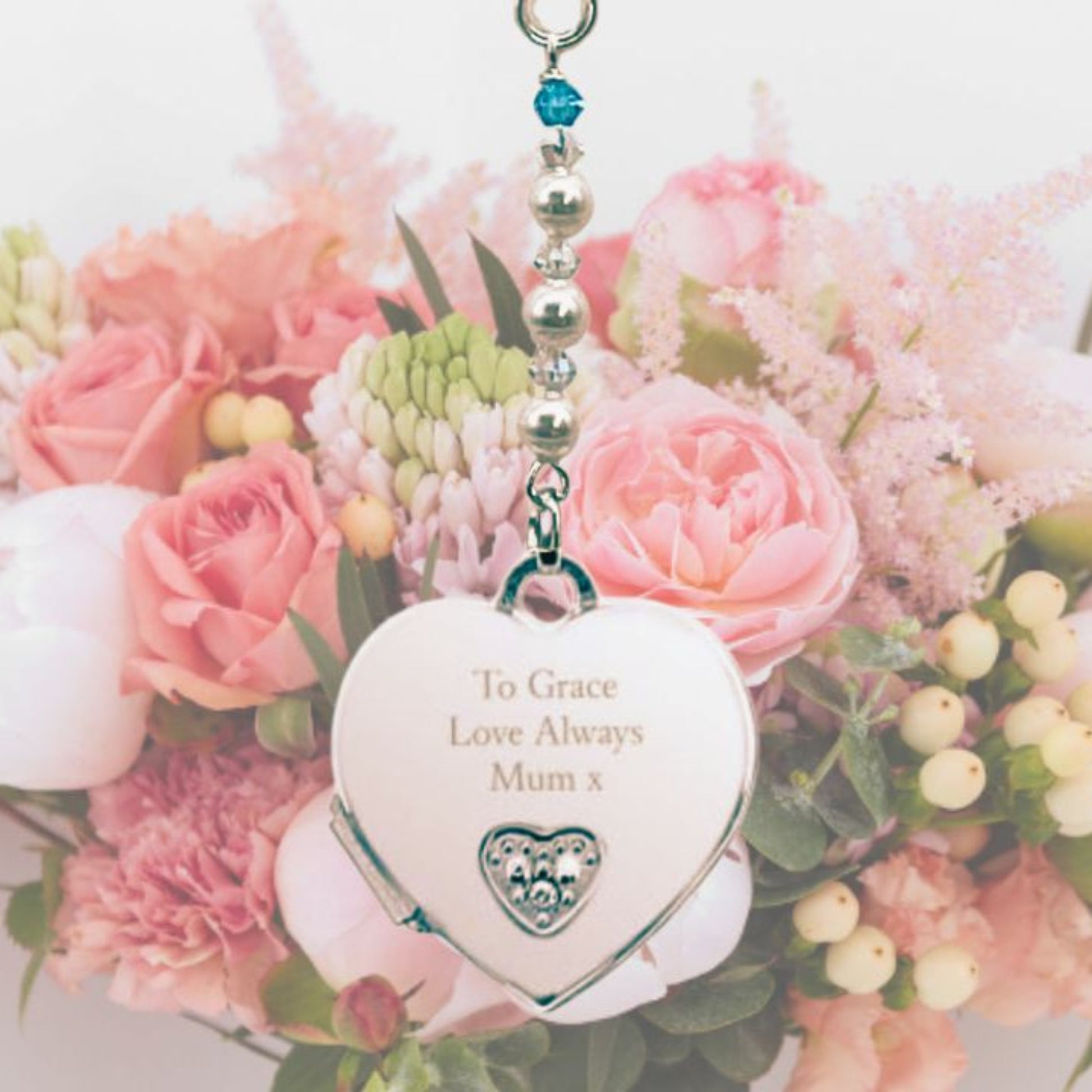 Sterling silver opening heart locket wedding bouquet charm  with tiny diamante engraved with text of your choice. Suspended from a string of white pearls and crystals and finished with a tiny blue crystal as a something blue