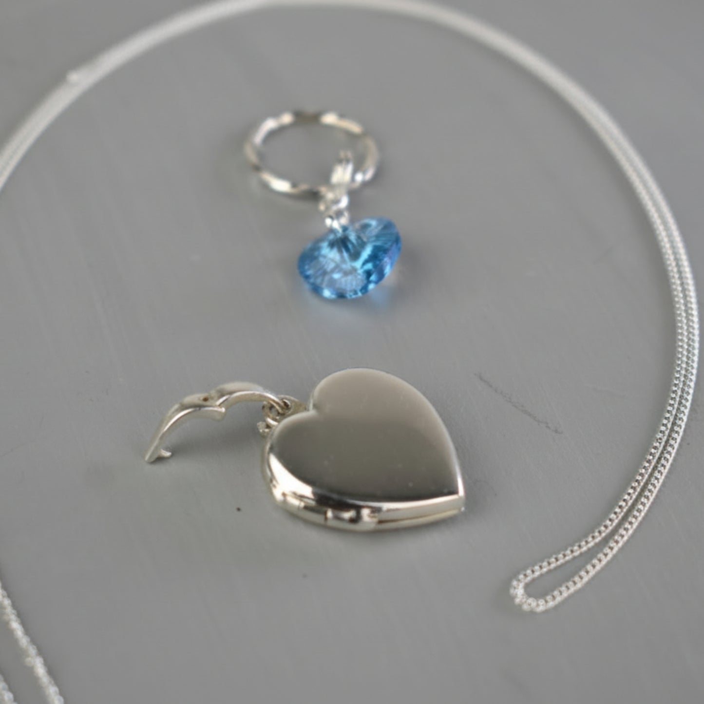 The locket can be detached from the bouquet by opening the bail and placing the heart locket onto a chain.