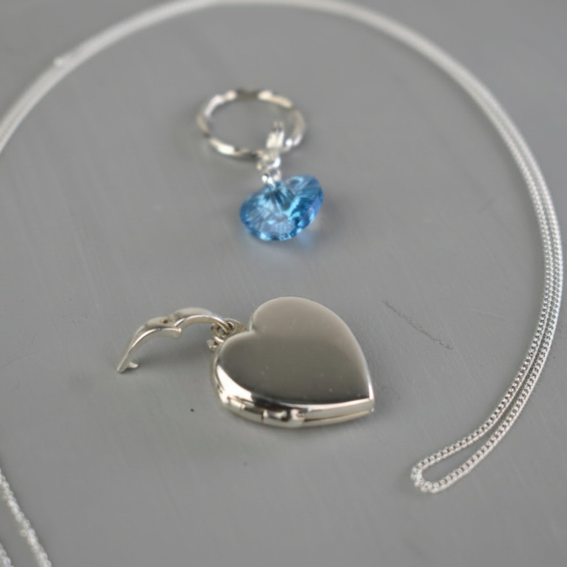 The locket can be detached from the bouquet by opening the bail and placing the heart locket onto a chain.