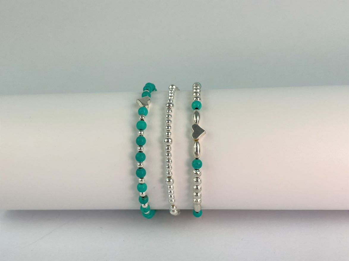 turquoise beaded bracelet shown with elasticated bracelet of silver beads and fancy turquoise and silver bracelet