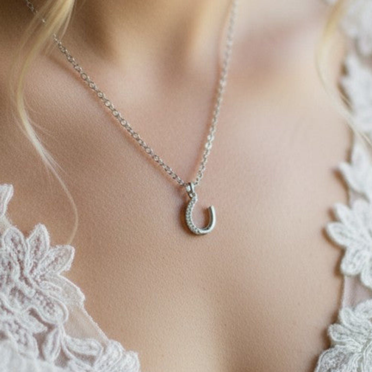 The pretty horseshoe charm can be detached and added to the optional chain so that it can be worn long after the wedding day.