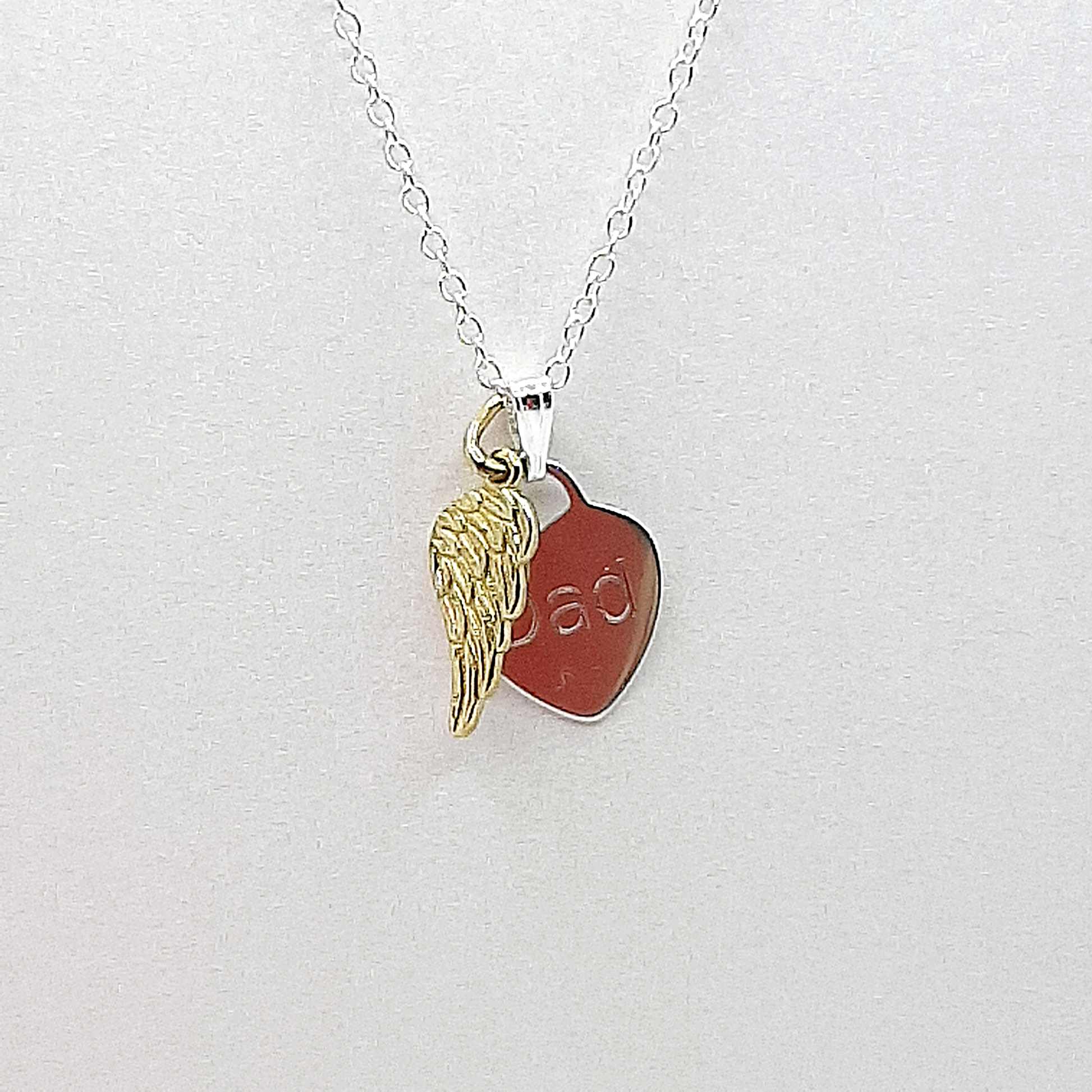 Gold vermeil on sterling silver angel wing is suspended from a sterling silver chain and accompanied by a sterling silver heart engraved with name of your choice. The pendant is mounted on high quality card with wording of your choice. This card is I have a guardian angel, I call him Dad.