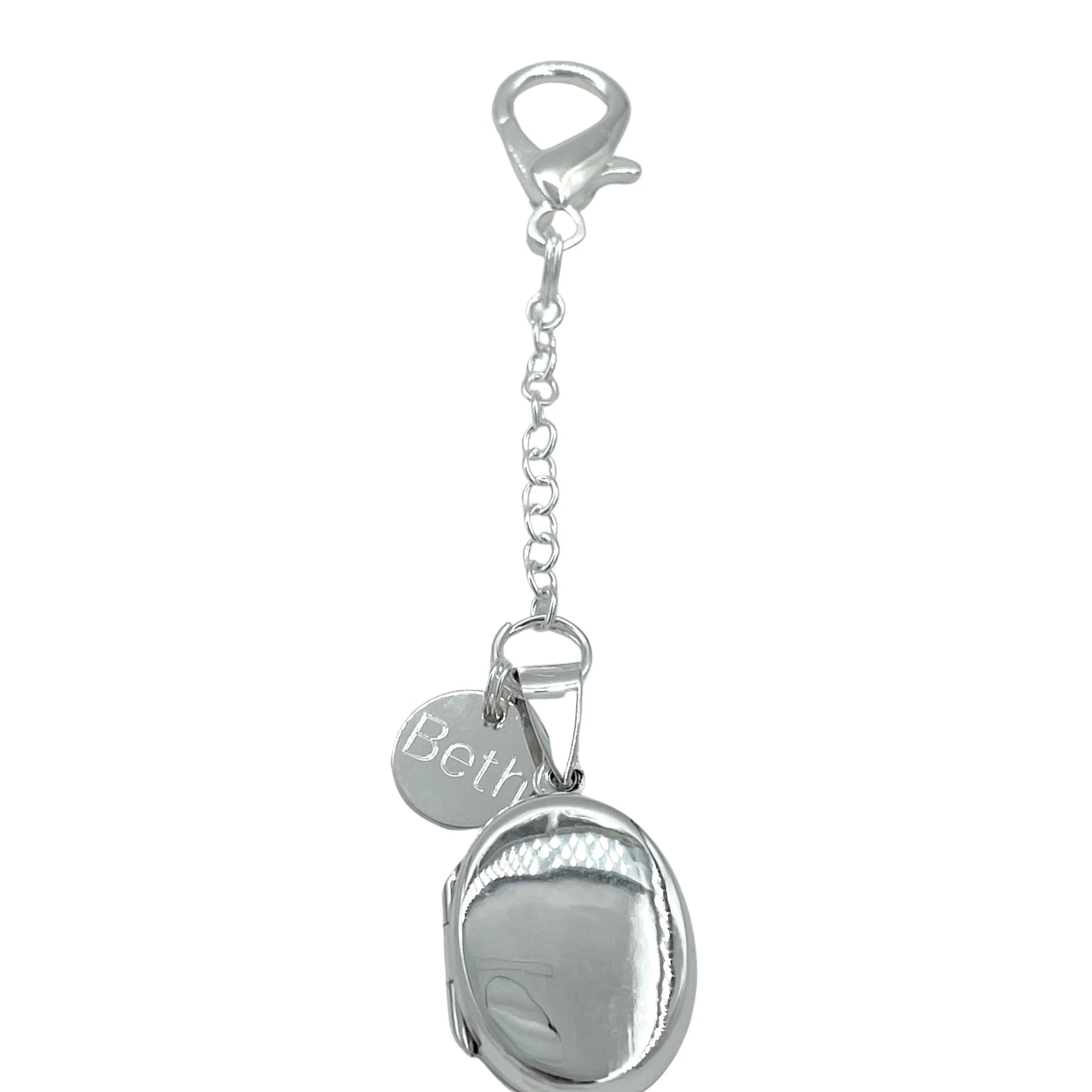 Sterling silver oval locket shown with lobster clasp fastening and optional engraved sterling silver tag