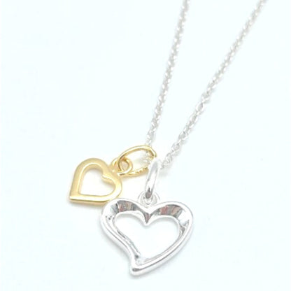 Message in a bottle jewellery - sterling silver open heart teamed with a smaller gold vermeil heart and suspended from a sterling silver chain. Arrives in a glass bottle with a scroll carrying personalised message of your choice