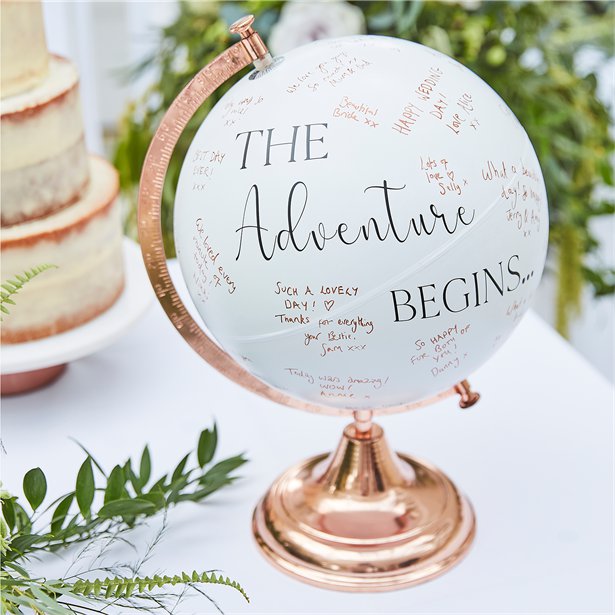 globe wedding guest book with the slogan "The Adventure Begins"