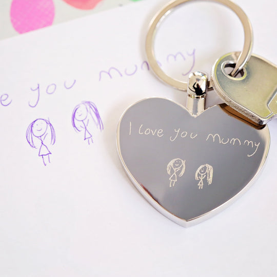 Silver metal heart shaped keyring shown with engraved message in own handwriting and drawings