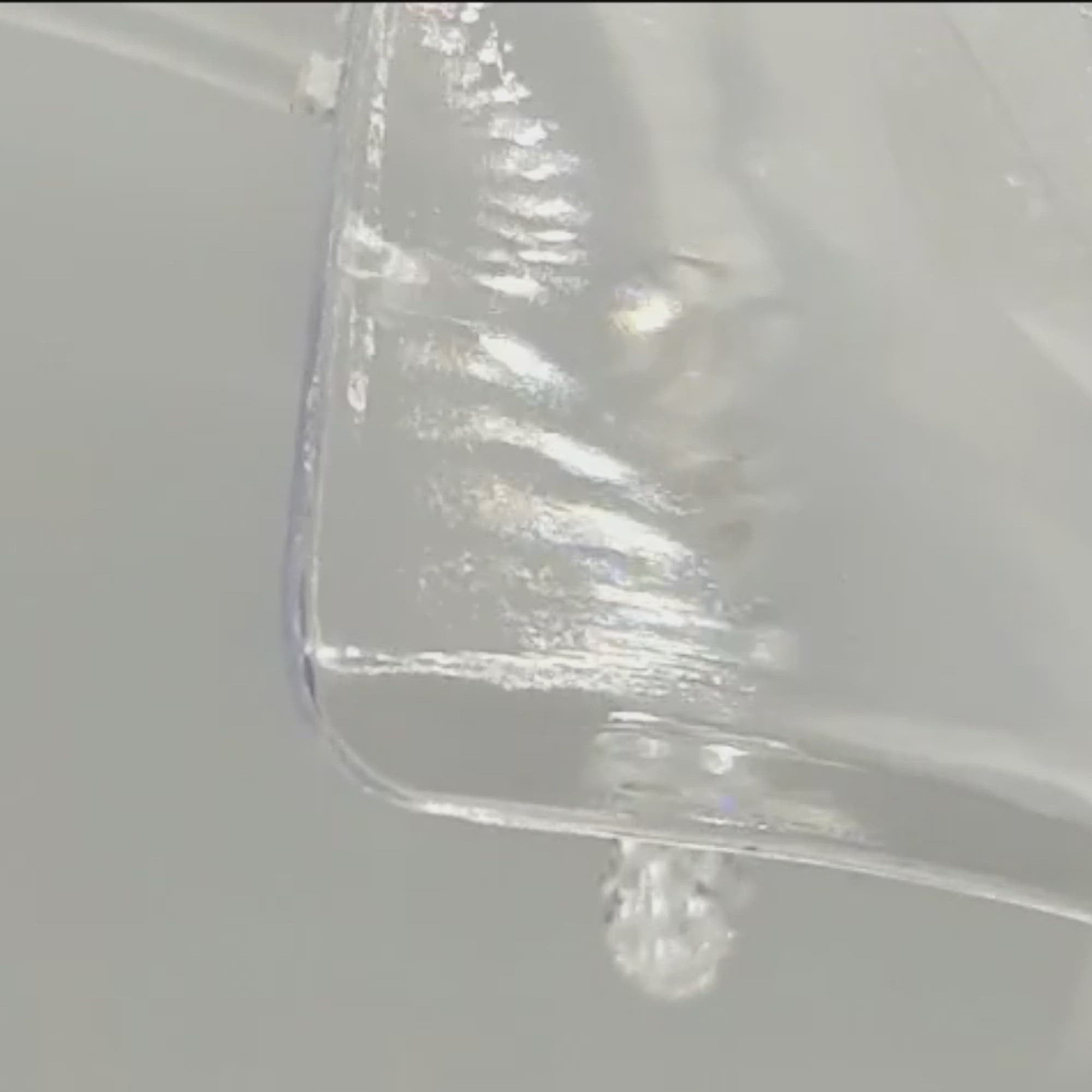video of wedding bells charm. Crystal circle encasing two crystal wedding bells topped with a silver bow. Each bell has a tiny blue bead for Something Blue.