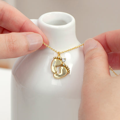 Gold plated baby feet pendant with crystal. One foot has baby's name and the other their birth date