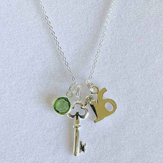 Pretty 16th birthday charm with a key pendant and birthstone 