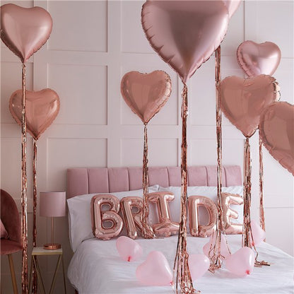 Decoration kit for the Bride's bedroom on the morning of the wedding. With rose gold heart balloons, tassels, and balloons spelling Bride