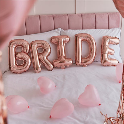 Decoration kit for the Bride's bedroom on the morning of the wedding. With rose gold heart balloons, tassels, and balloons. Close up of balloons  spelling Bride