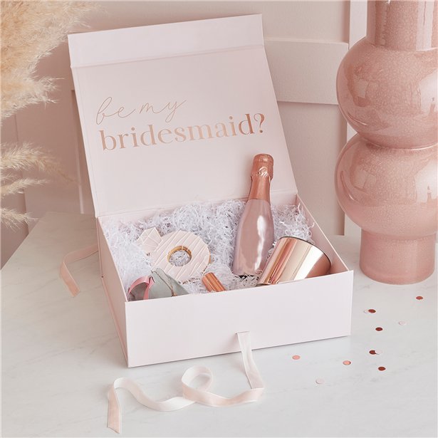 Pretty gift box with magnetic closure and velvet ribbon has rose gold foil lettering on the inside stating "be my bridesmaid". Suggested content also shown