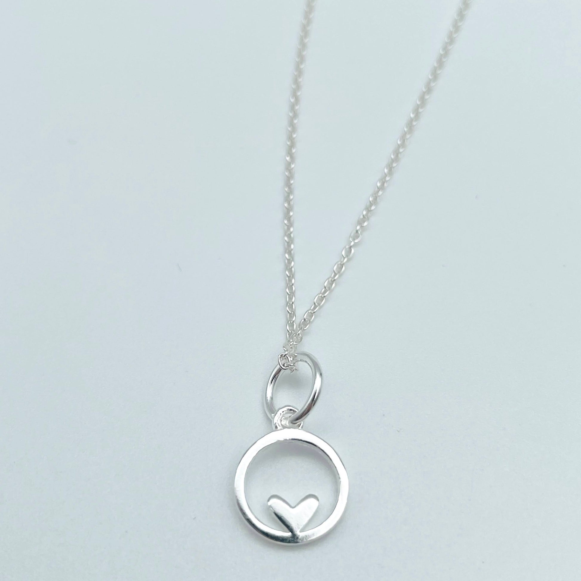 A small sterling silver circle encases a tiny sterling silver heart and is hung from a sterling silver chain. The necklace is placed in a glass bottle which also includes a scroll with a message in your wording. Part of our Message in a Bottle range. Your pendant includes a luxury gift pouch and eco-friendly packaging