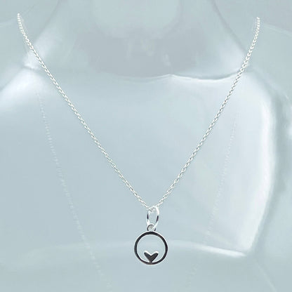 Sowing chain with sterling silver circle pendant with a small heart at the bottom of the circle