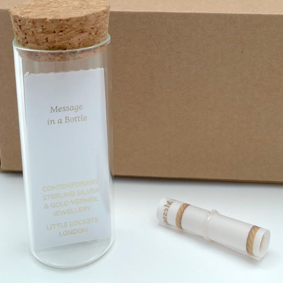 Message in a Bottle Range from Little Lockets London showing reverse of jewellery card, glass bottle with cork top and scroll for your message and eco-packaging