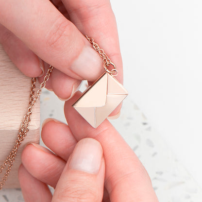 Rose gold plated envelope necklace, shown closed