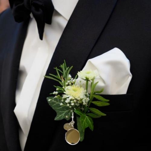 Sterling silver locket on groom's lapel
