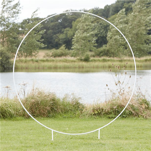 A large white hoop that is free standing and can be used for flower or balloon displays.