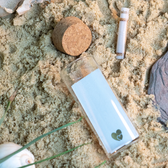 Glass bottle for message in a bottle earrings, shown with rolled parchment scroll