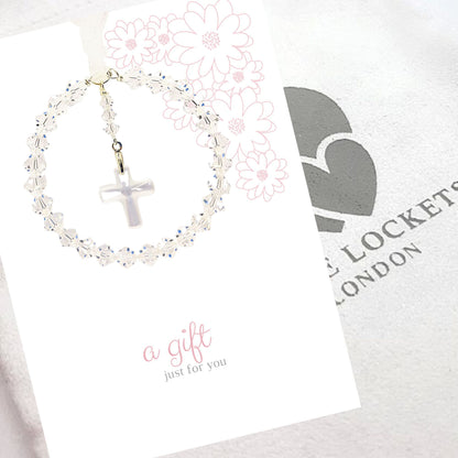 A circle of high grade austrian crystals surrounds a crystal cross suspended from the centre of the circle. Sparkling crystal ribbon completes the charm. Shown on a pre-printed card with the message "a gfit just for you". Luxury pouch is in background.