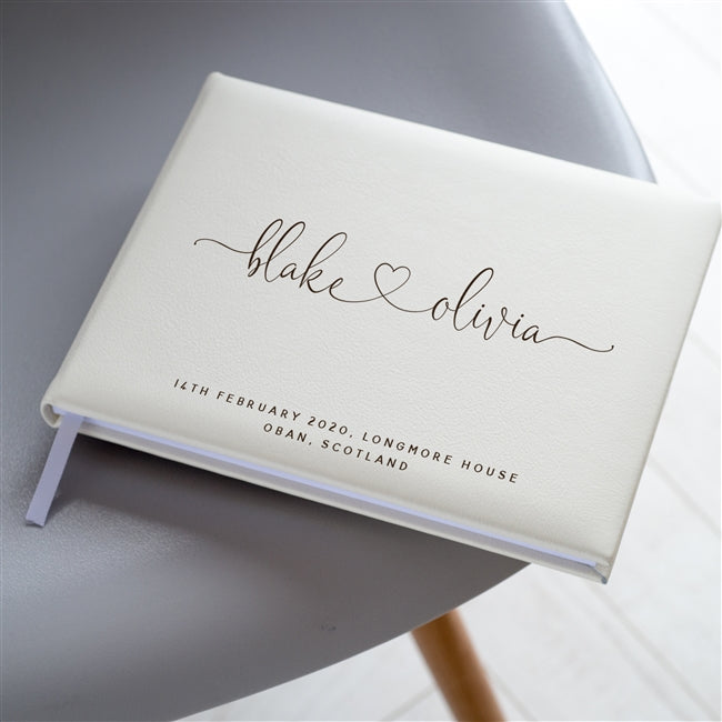 Ivory Italian leather wedding guest book personalised with the couple's names and details of their wedding