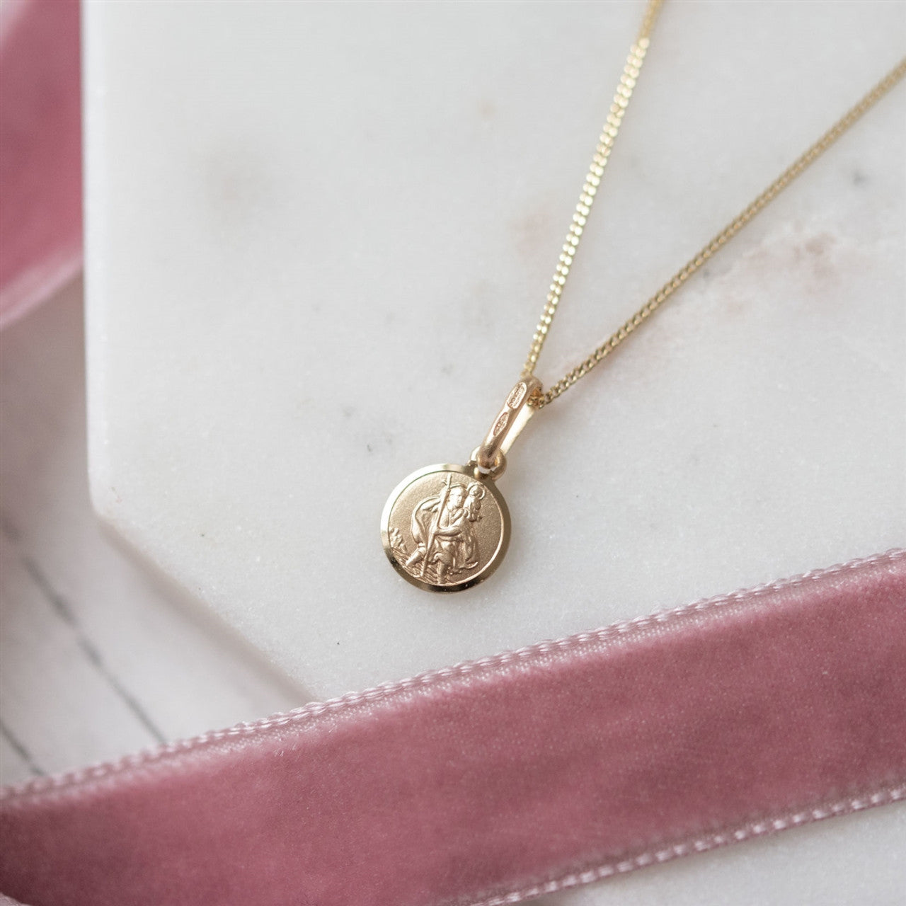 Tiny st christopher shown in 9 ct gold