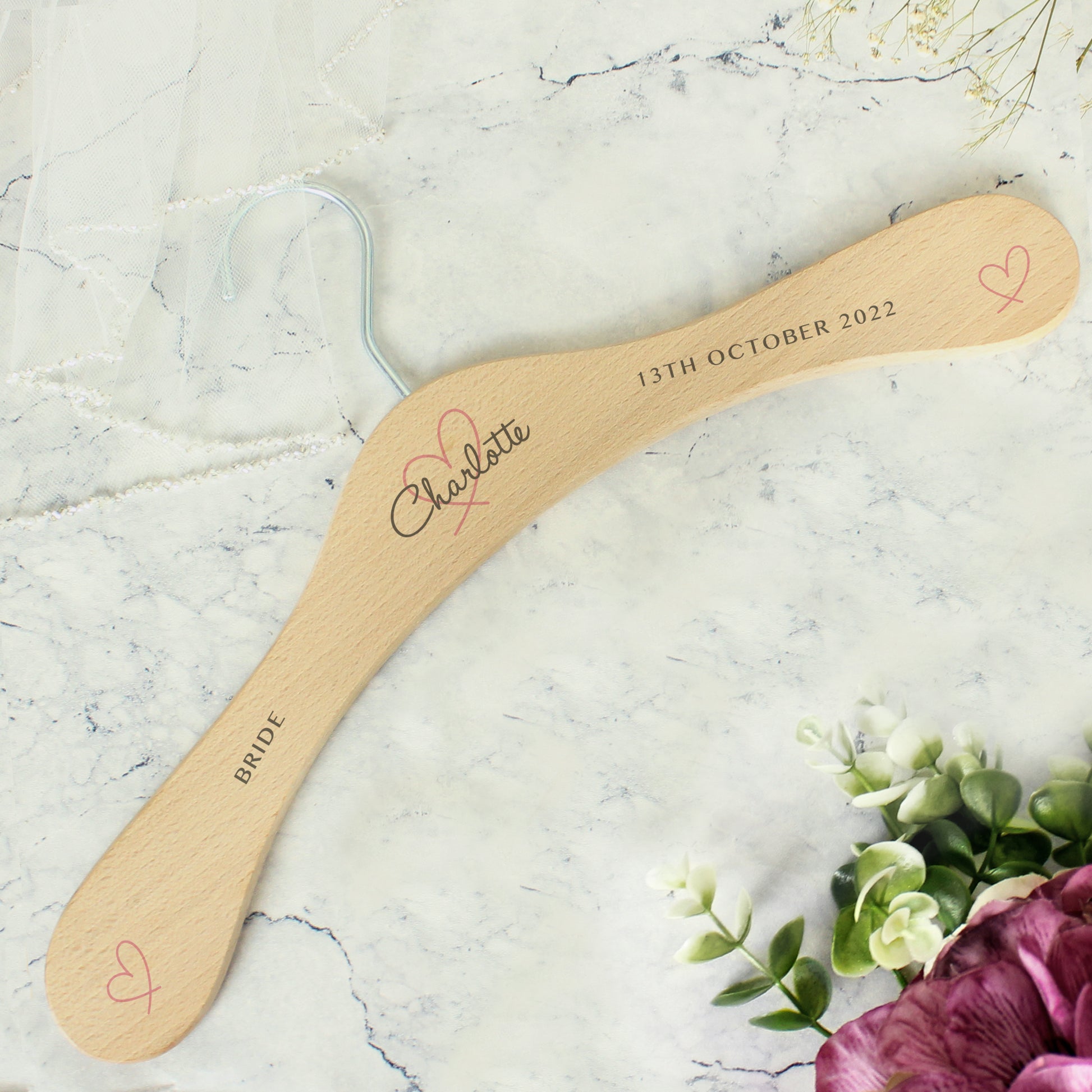Perfect for identifying and keeping safe those special dresses. The wooden personalised wedding hanger has a pretty heart design with room for three lines of text across the hanger. 