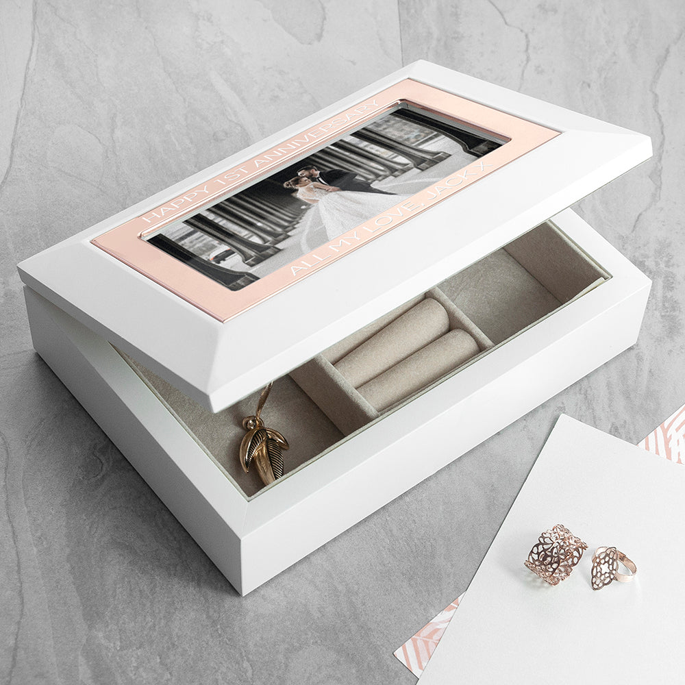 White matt wood jewellery box with rose gold frame around photo of your choice. Add up to two lines of text. Nude suede interior keeps jewellery scratch free