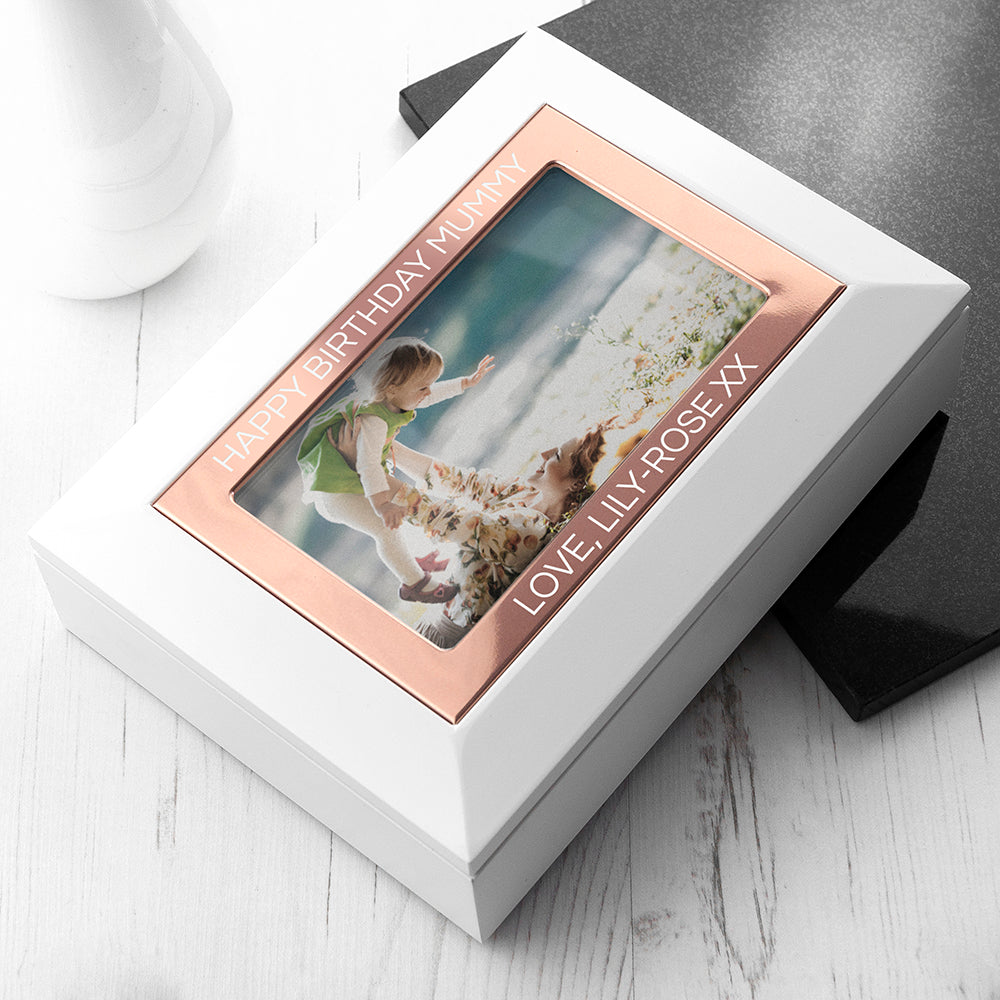 White matt wood jewellery box with rose gold frame around photo of your choice. Add up to two lines of text. Nude suede interior keeps jewellery scratch free