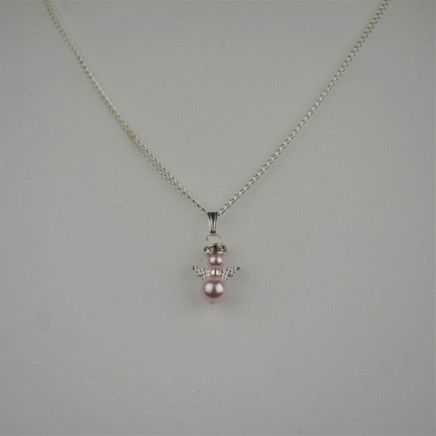 Snow angel pendant in pale pink pearl on a 16" silver plated chain