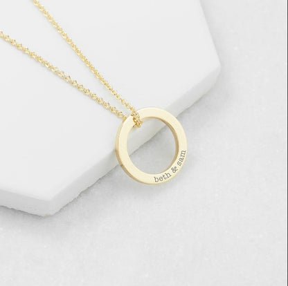 gold plated ring charm necklace engraved with the words "beth & sean" and suspended from an 18" gold plated chain