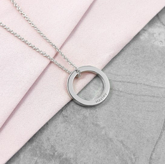 silver plated ring charm necklace engraved with a name and suspended from an 18" silver chain