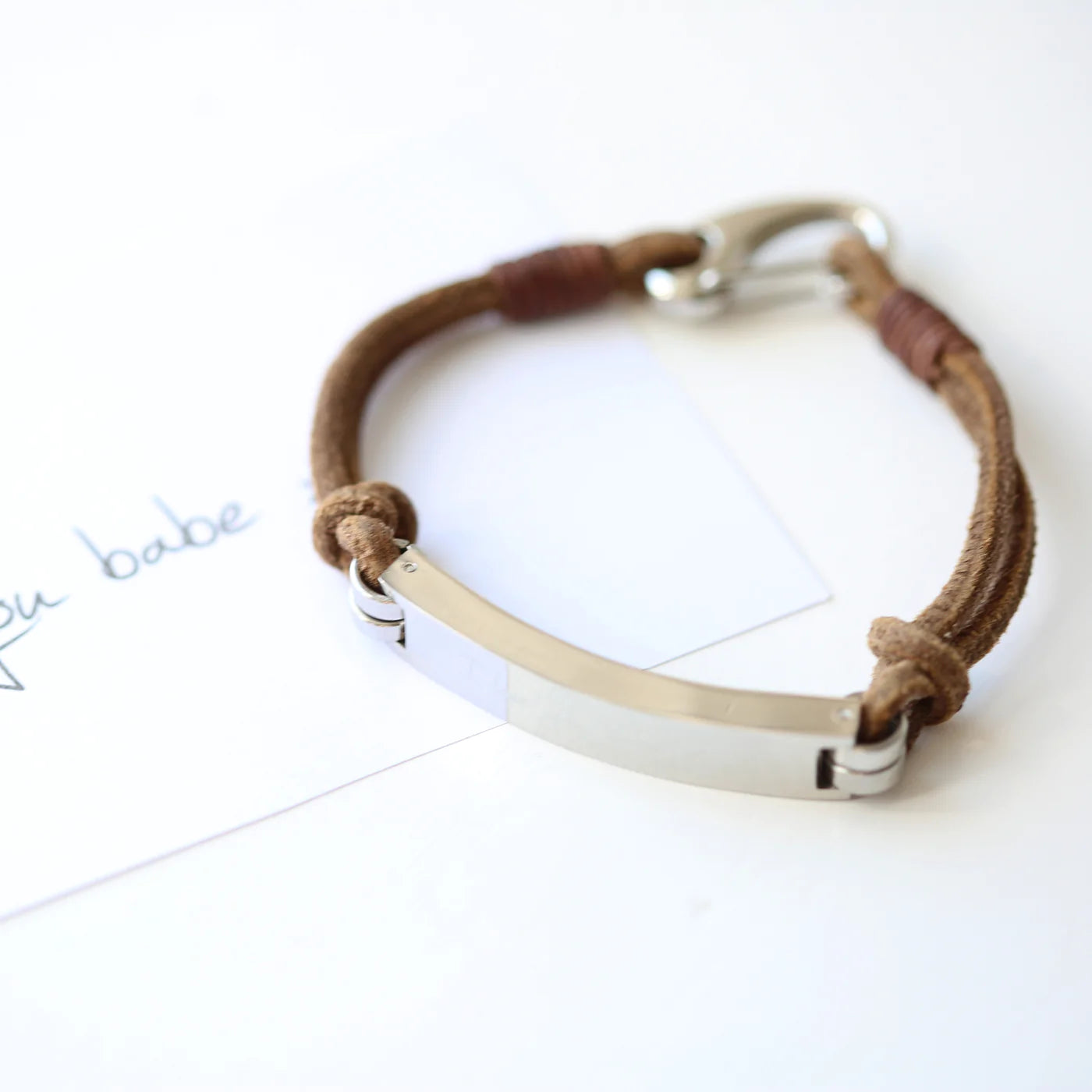 Leather bracelet with heavy silver clasp and silver bar engraved with the message of your choice in your own handwriting. Showing thickness of bar