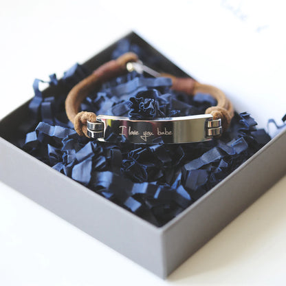 Leather bracelet with heavy silver clasp and silver bar engraved with the message of your choice in your own handwriting. Shown in gift box