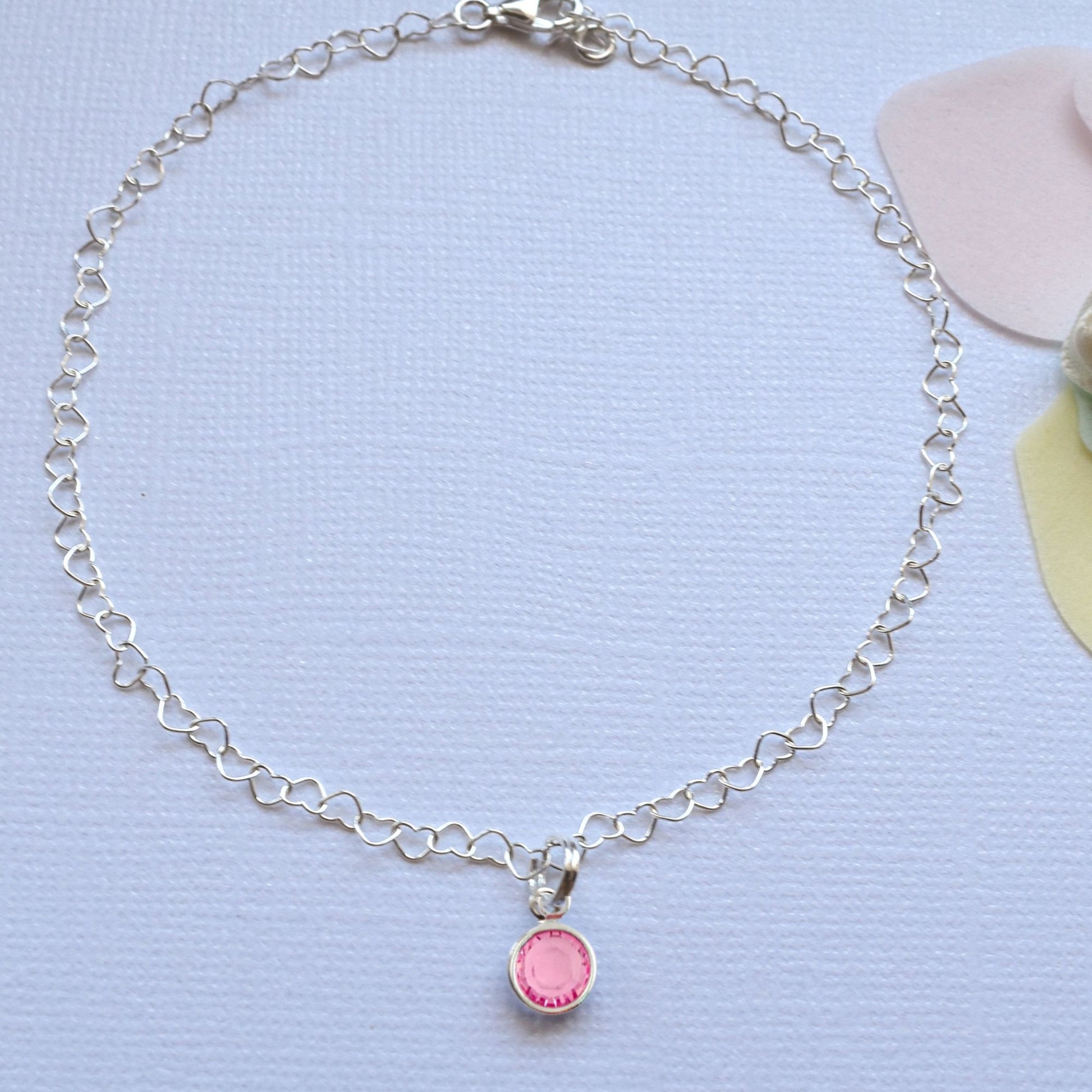 beautiful anklet with heart shaped lines and adorned with a single birthstone of your choice.  Sterling silver.