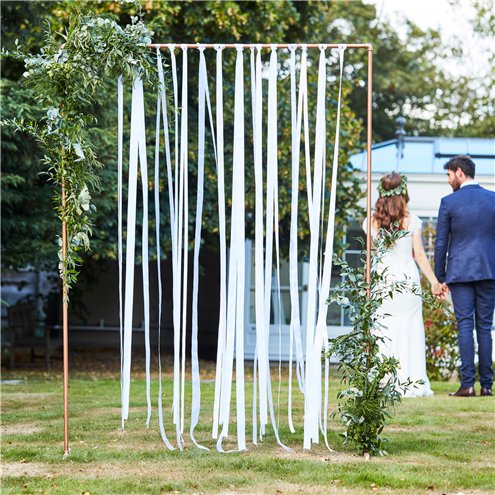 copper arch frame shown with ribbon curtain