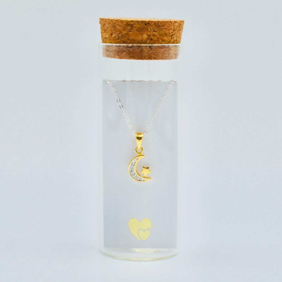 gold vermeil crescent moon with cubic zircona and tiny star on a sterling silver chain in a glass bottle with cork top. Little Lockets London Message In a Bottle range