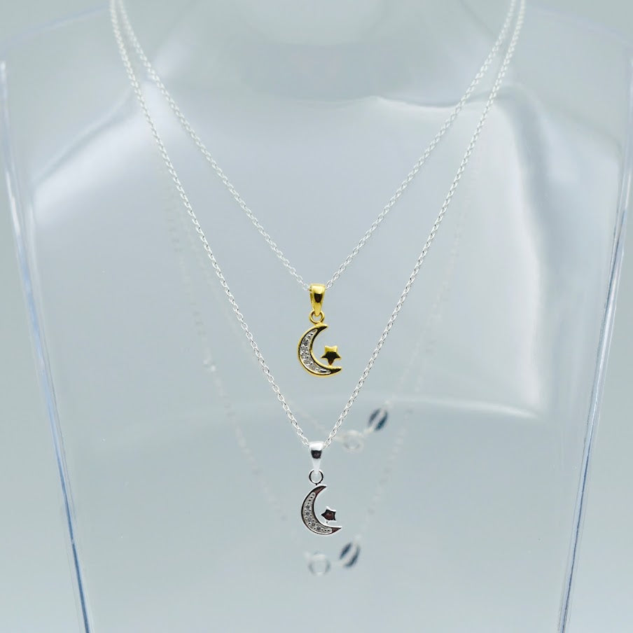 sterling silver and gold vermeil necklaces with cubic zircona crescent moon and tiny star shown worn together on display bust. Part of the Little Lockets London Message in a Bottle range.