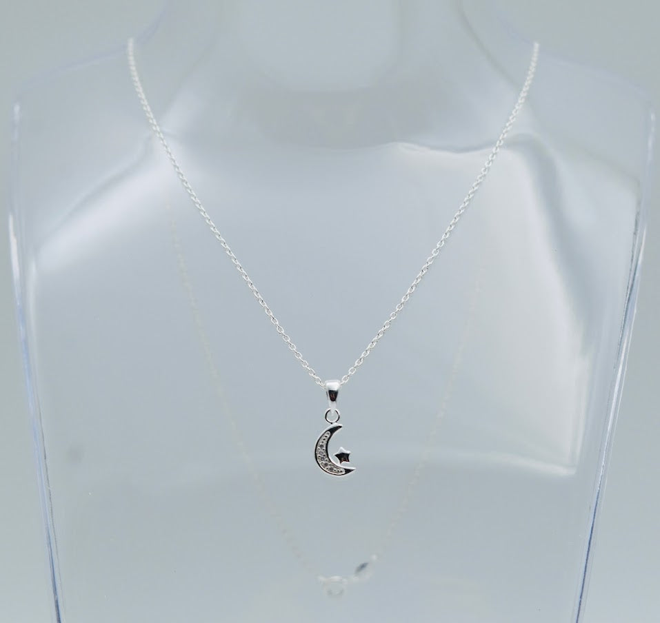 sterling silver crescent moon with cubic zircona and a tiny star hung from a sterling silver chain, shown on a display bust, Little Lockets London Message in a Bottle range