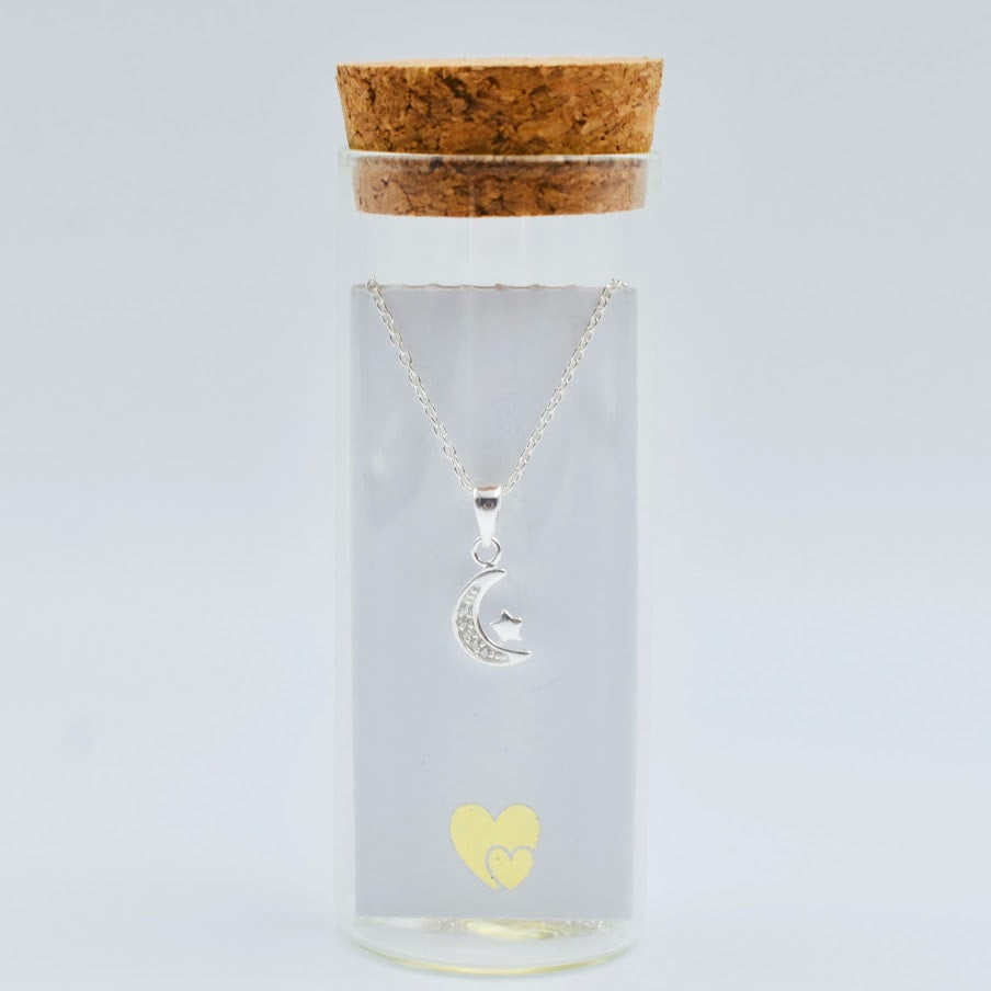 sterling silver crescent moon with cubic zircona and tiny star on a sterling silver chain in a glass bottle with cork top. Little Lockets London Message In a Bottle range