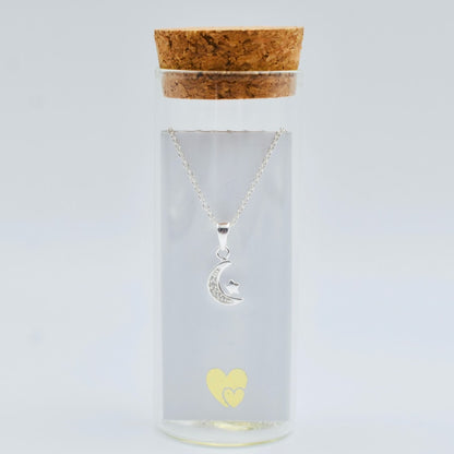 sterling silver crescent moon with cubic zircona and tiny star on a sterling silver chain in a glass bottle with cork top. Little Lockets London Message In a Bottle range