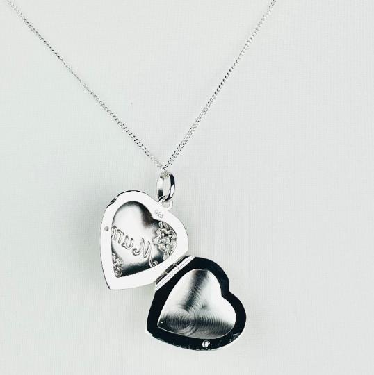Sterling silver heart shaped locket engraved with the word "Mum" in script and flower decoration. Suspended from a sterling silver chain  open view