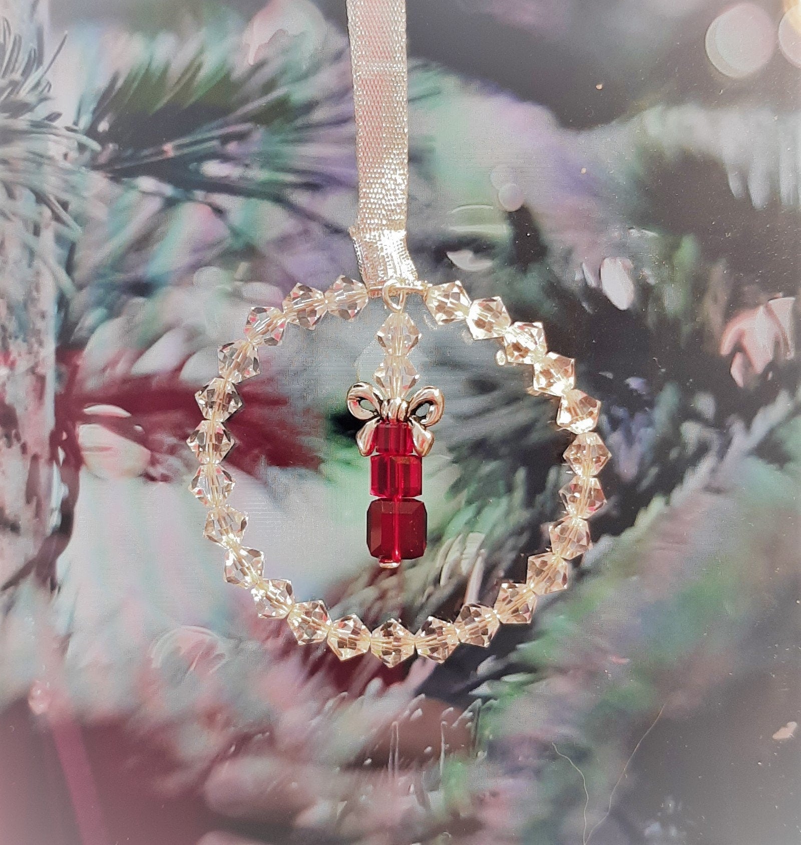 High quality clear crystals form a ring around a stack of cube crystals topped with a silver bow and finished with ribbon. Christmas tree ornament.