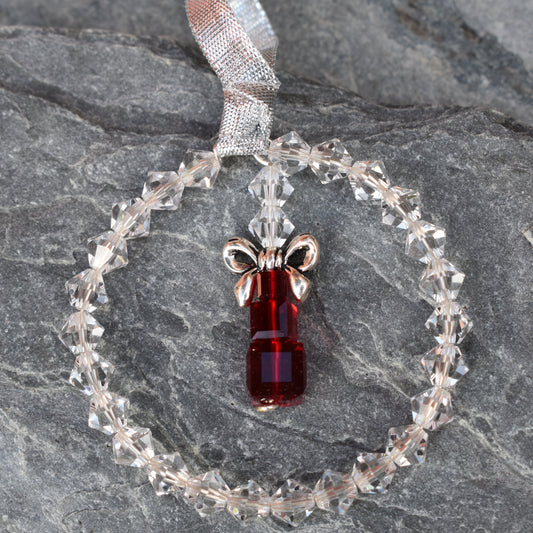 High quality clear crystals form a ring around a stack of cube crystals topped with a silver bow and finished with ribbon. Christmas tree ornament.
