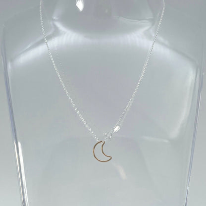 Gold vermeil hollow crescent moon hung from a sterling silver chain . Part of the Message in a Bottle range