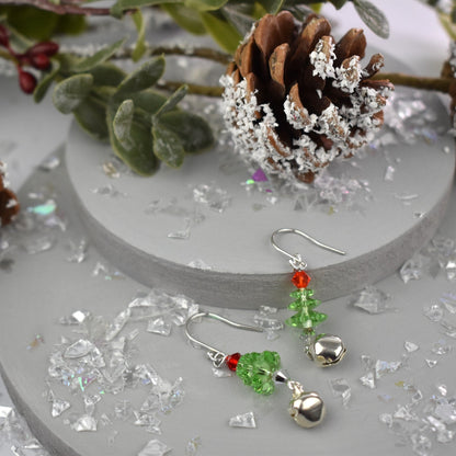 Christmas tree earrings made from high quality crystals, green Christmas tree is topped with a red crystal . Real jingle bell is suspended from each tree. Hung on sterling silver ear wires.