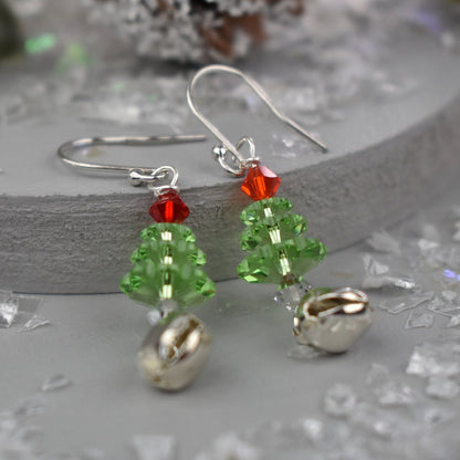 Christmas tree earrings made from high quality crystals, green Christmas tree is topped with a red crystal . Real jingle bell is suspended from each tree. Hung on sterling silver ear wires.